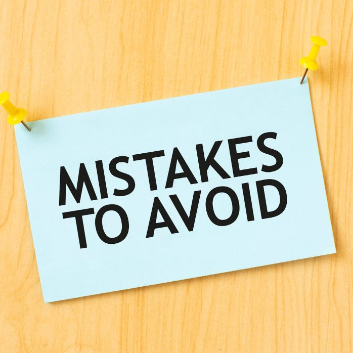  MISTAKES TO AVOID sign written on sticky note pinned on wooden wall