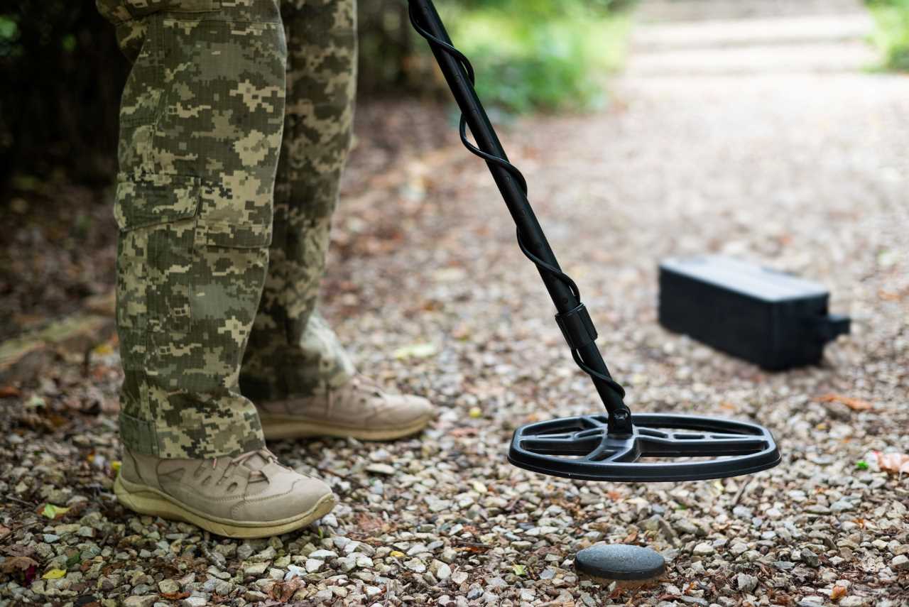 detectorist holding a metal detector