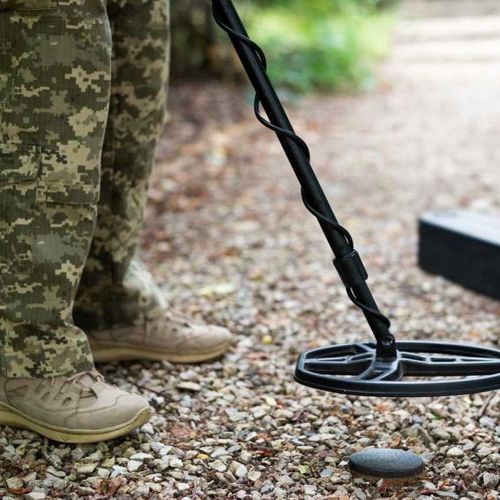 detectorist holding a metal detector