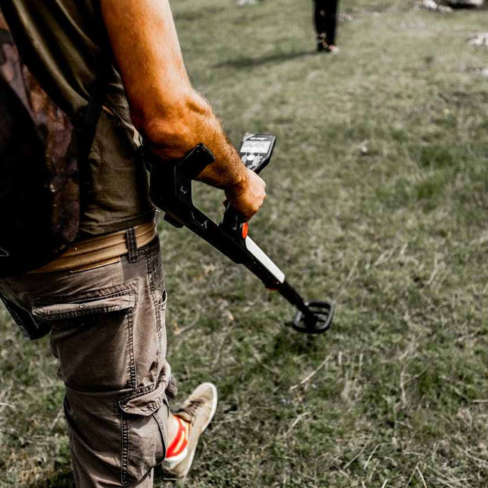 man holding a metal detector